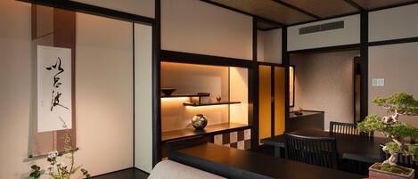 A traditional Japanese-style room with tatami flooring, a low table, and a sofa.