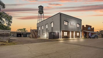 A building with a sign reading 'Salt Block Texas Salt Co.' and a water tower in the background.
