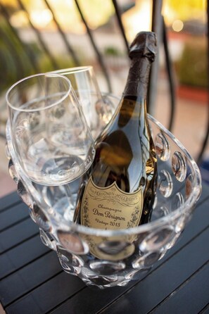 A bottle of Dom Pérignon vintage 2013 champagne in a glass holder with a glass. - SUITE APARTMENT TAORMINA (Taormina)