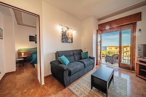 Panoramic Apartment, Balcony, Sea View | Living area | TV