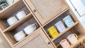 A wooden cabinet with four compartments, each containing different items. - Unique Little Charmer in Downtown Frederick

 (Frederick)