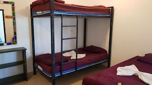 A bunk bed with a ladder, a small desk, and a mirror. - Hotel Casa Blanca (San Pedro La Laguna)