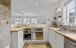 Fridge, dishwasher, coffee/tea maker, cookware/dishes/utensils