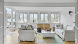A spacious living room with white furniture, large windows, and a view of the outdoors. - Amazing home in Hornbæk with WiFi (Hornbæk)