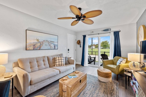 Bright, airy living room filled w/ natural light & comfy seating to relax together.