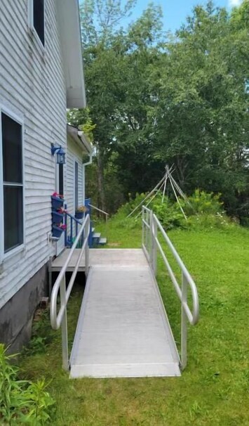 Entrance with ramp and steps  on the other side of the ramp
