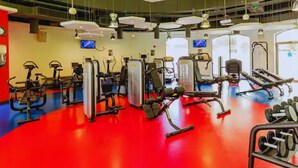 A gym with various exercise equipment, including treadmills, weight machines, and dumbbells. - Russian Beach  JBR (Dubai)