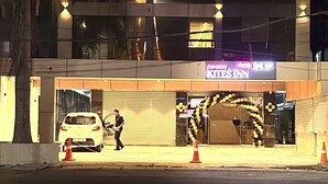 A hotel named Kites Inn with a modern facade, multiple floors, and a neon sign. - Nexstay Kites Inn (Bengaluru)