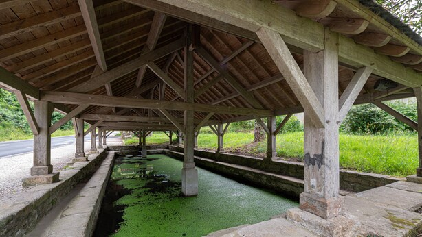 A covered structure with a concrete channel running through it.
