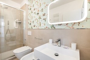 Een douche, een haardroger, een bidet, handdoeken