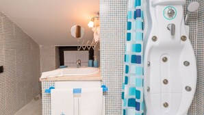 A bathroom with a white bathtub, a sink, and a mirror.