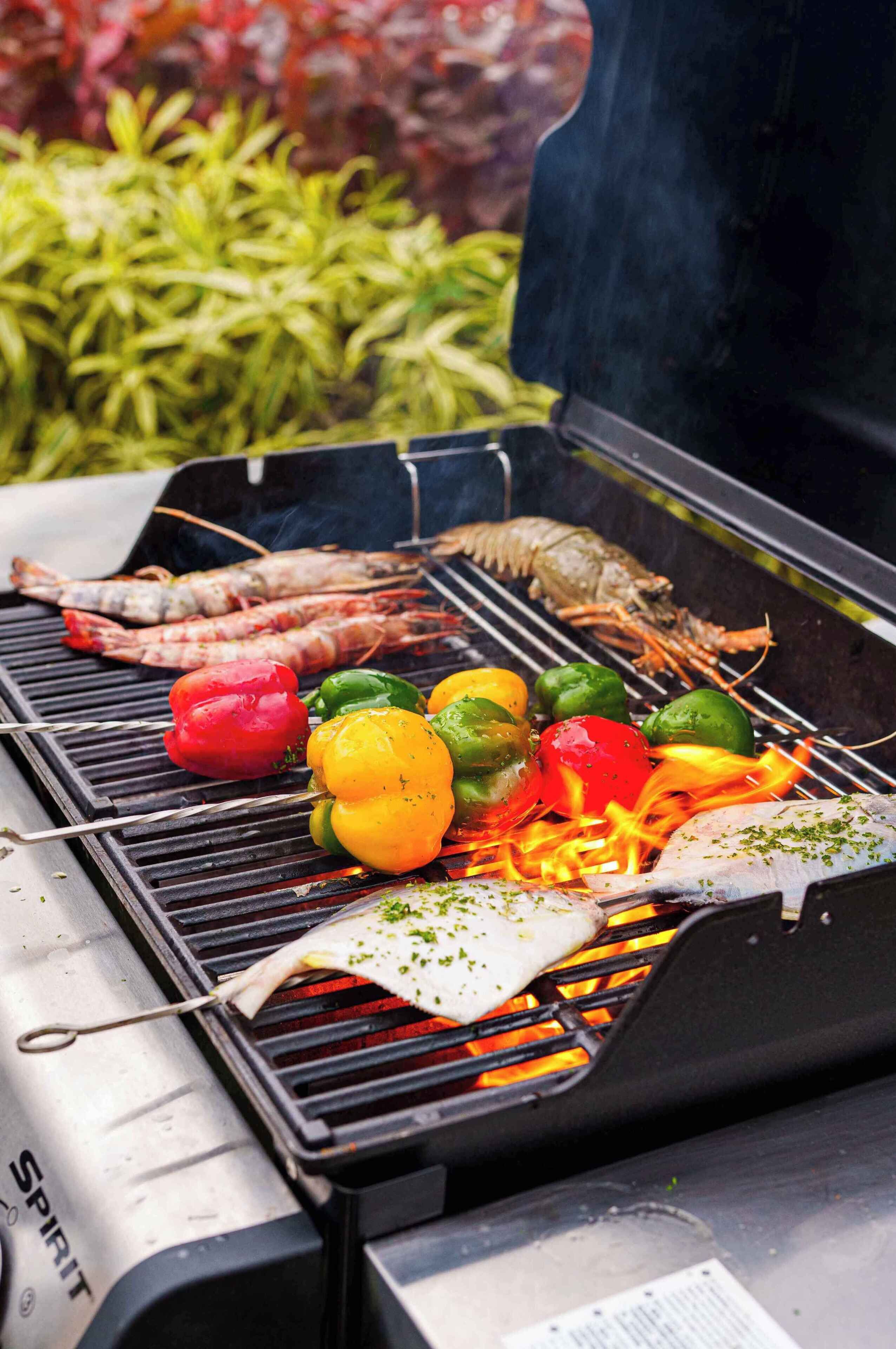Una parrilla con mariscos y verduras a la cocción.