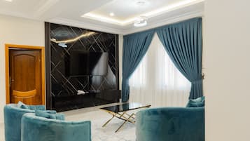 Luxury Apartment, 1 Bedroom | Living area | 50-inch Smart TV with satellite channels