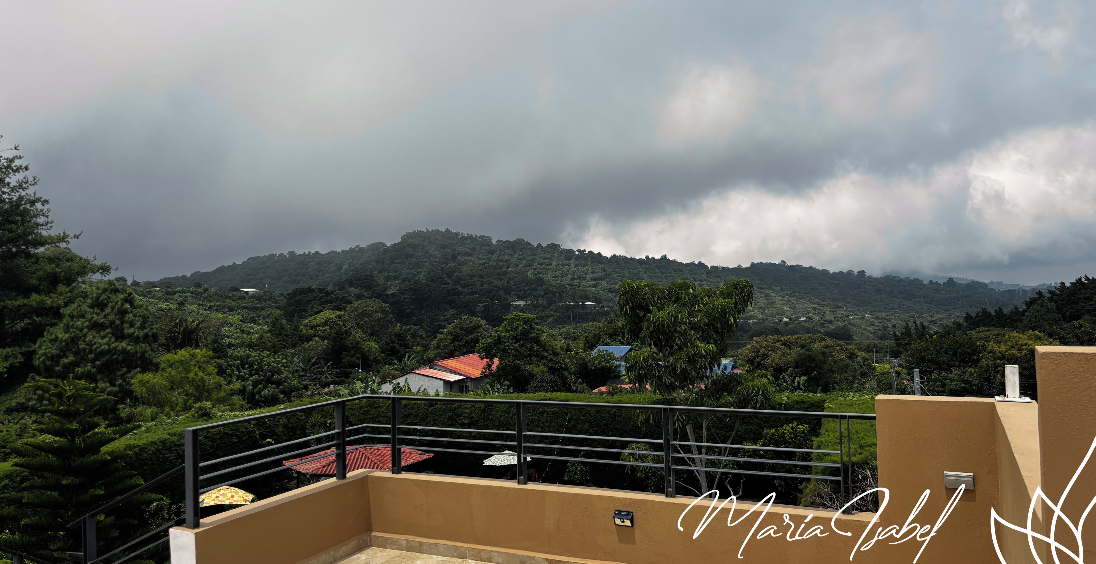 Terraço de hotel com vista para uma paisagem montanhosa.