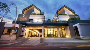 A modern hotel with a prominent 'Val Star Hotel' sign, a covered entrance, and a well-lit facade. - Valstar Hotel Canggu (Canggu)