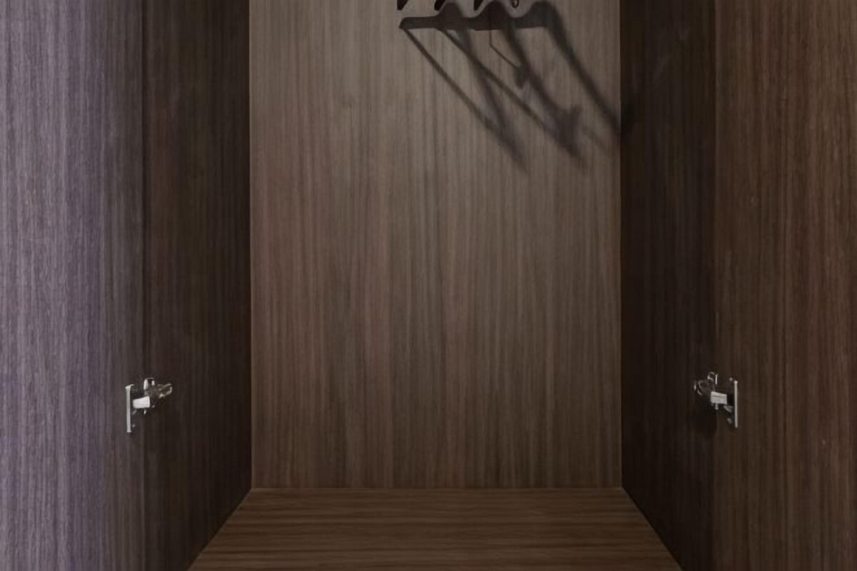 A room with wooden panel walls and a door with a handle.