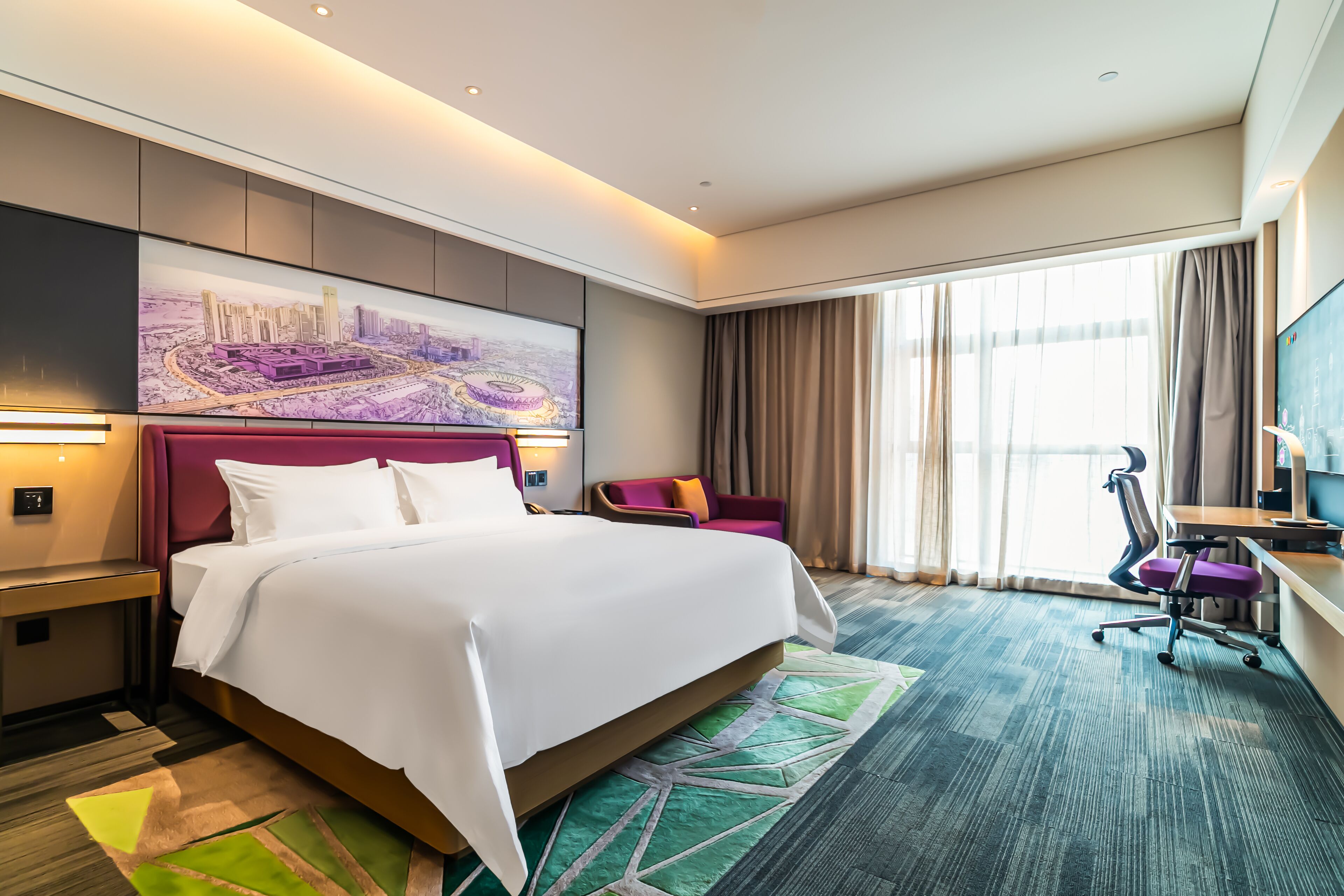 A hotel room with a large bed, a desk, a chair, a TV, and a cityscape painting on the wall.