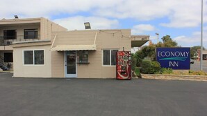 A small building with a sign for Economy Inn. - ECONOMY INN (Santa Maria)