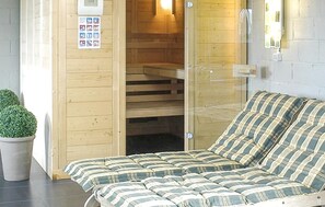 A wooden room with a bed, a small potted plant, and a sauna. - Pet friendly home in Durbuy with Wi-Fi (Durbuy)