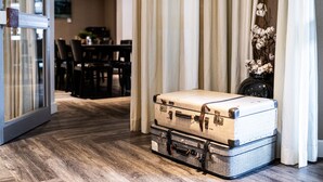 A hotel lobby with a wooden floor, a dining area in the background, and a large window with blinds. - Gruppe Meisenberg by Interhome (Winterberg)