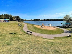 A park with a playground, a bench, and a path leading to a lake. - Ford's Talpine Cottage on Echo Lake (Mercer)