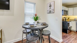 A dining area with a round table, four stools, a potted plant, and a painting on the wall. - Dog-Friendly Sheboygan Home - 1 Mi to Town! (Sheboygan)