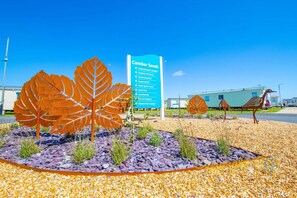 A sign for Camber Sands with amenities like an entertainment complex, outdoor pool, and a supermarket. - SP90 - Camber Sands Holiday Park - Dog Friendly (Camber)