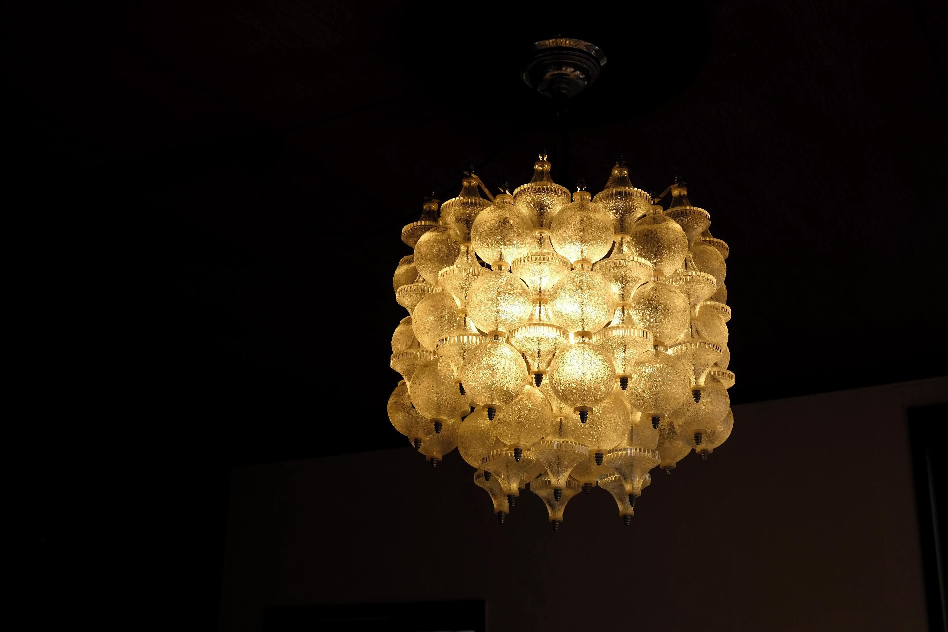 A chandelier with multiple spherical glass elements and a central fixture.