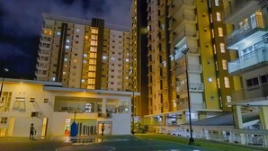 A high-rise building with multiple floors, balconies, and a well-lit entrance area. - MESAVERTE STUDIO UNIT (Cagayan de Oro)