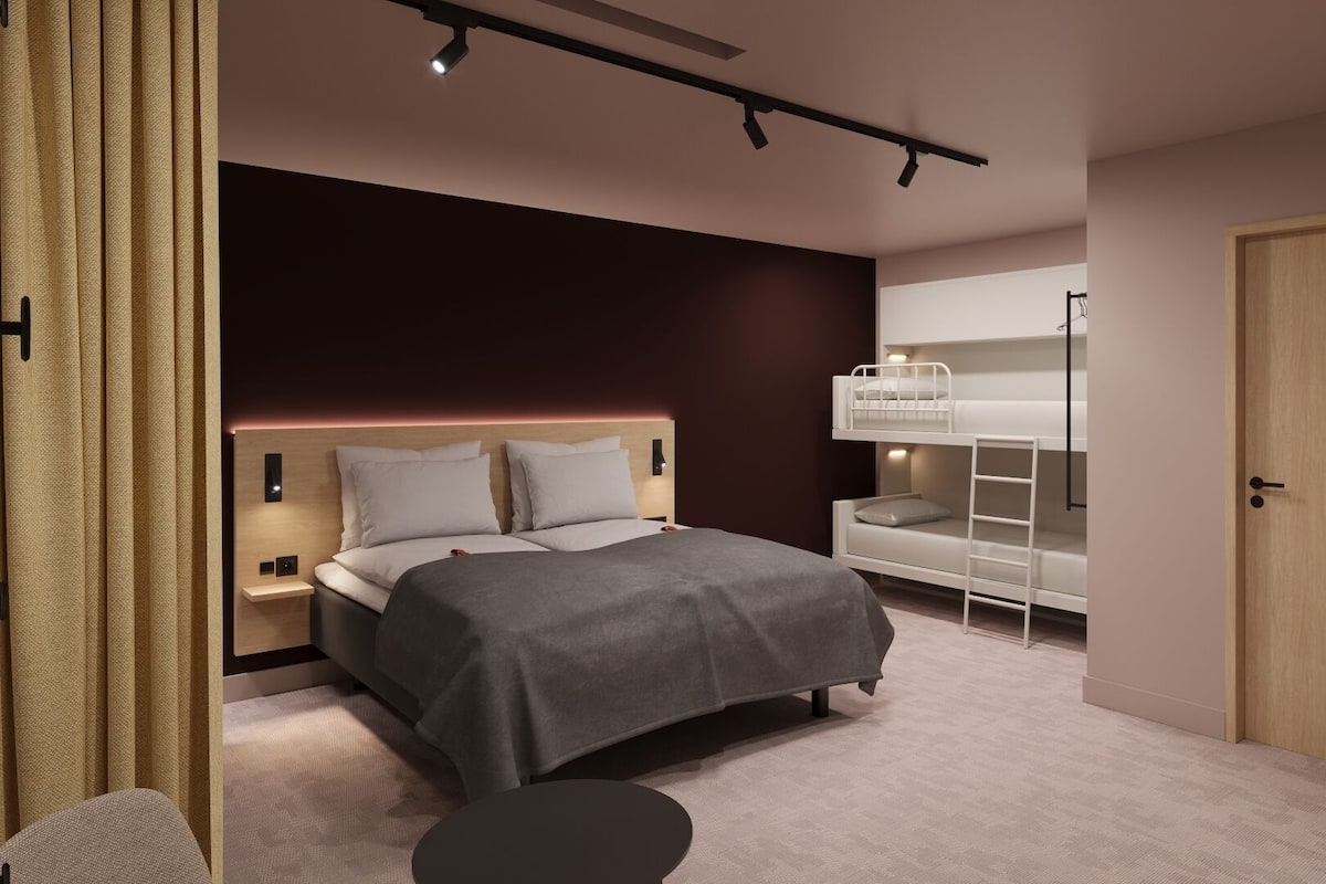 A modern bedroom with a bed, bedside tables, a desk, and a bunk bed.