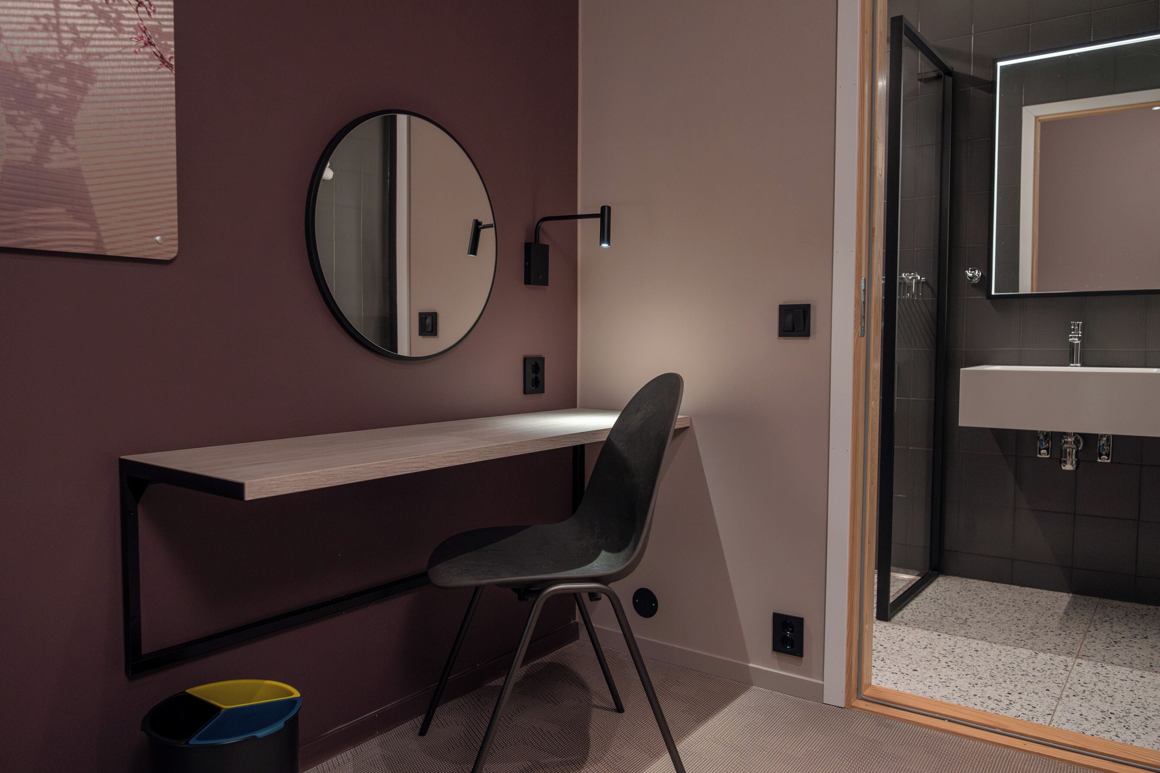 A modern bathroom with a shower, a sink, and a mirror.