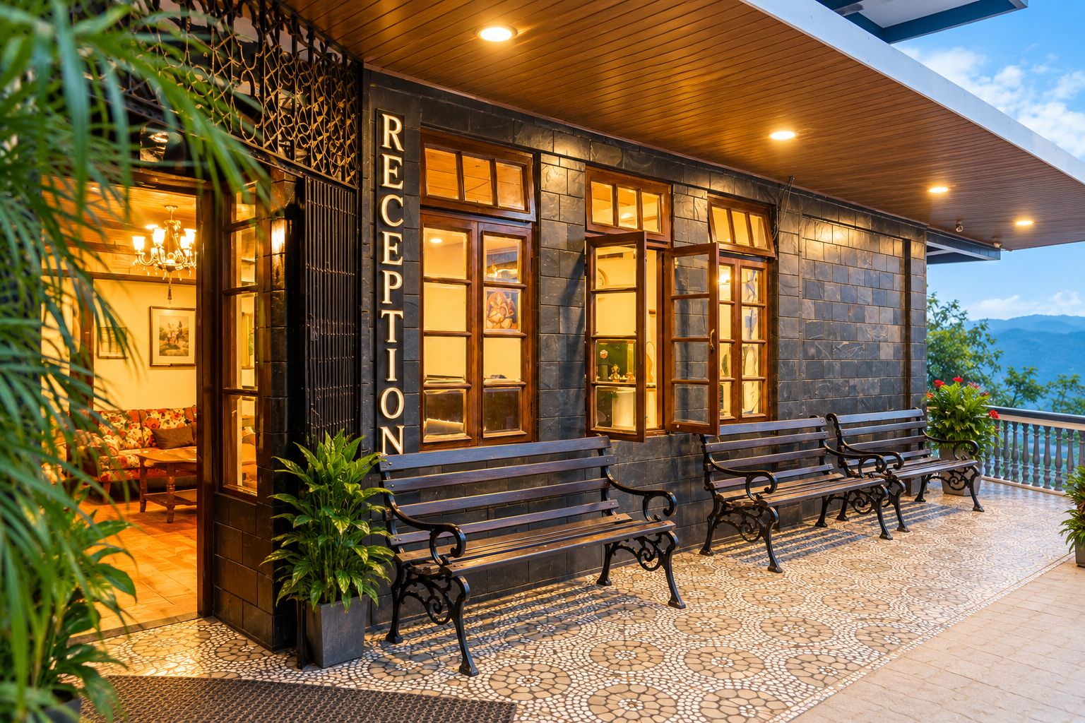 A reception area with a stone facade, wooden benches, and a view of the landscape.