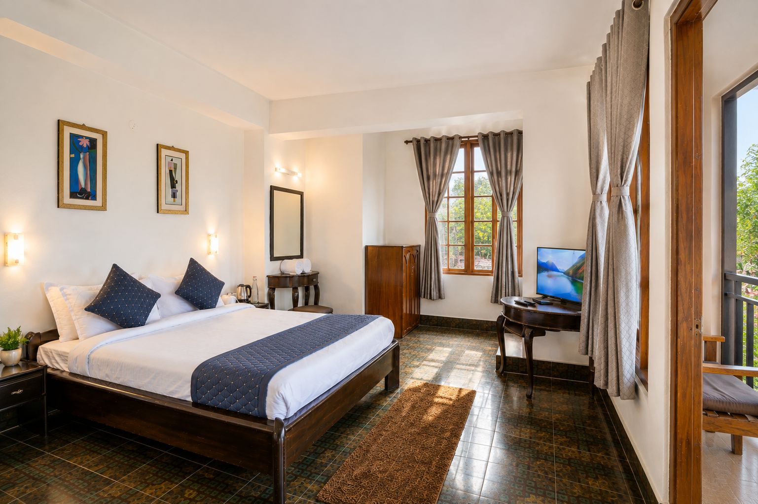 A hotel room with a bed, a desk, a TV, and a window with curtains.