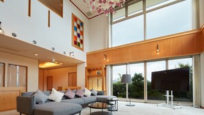Un espacio habitable amplio con un sofá modular, una mesa de centro y un televisor de pantalla plana.