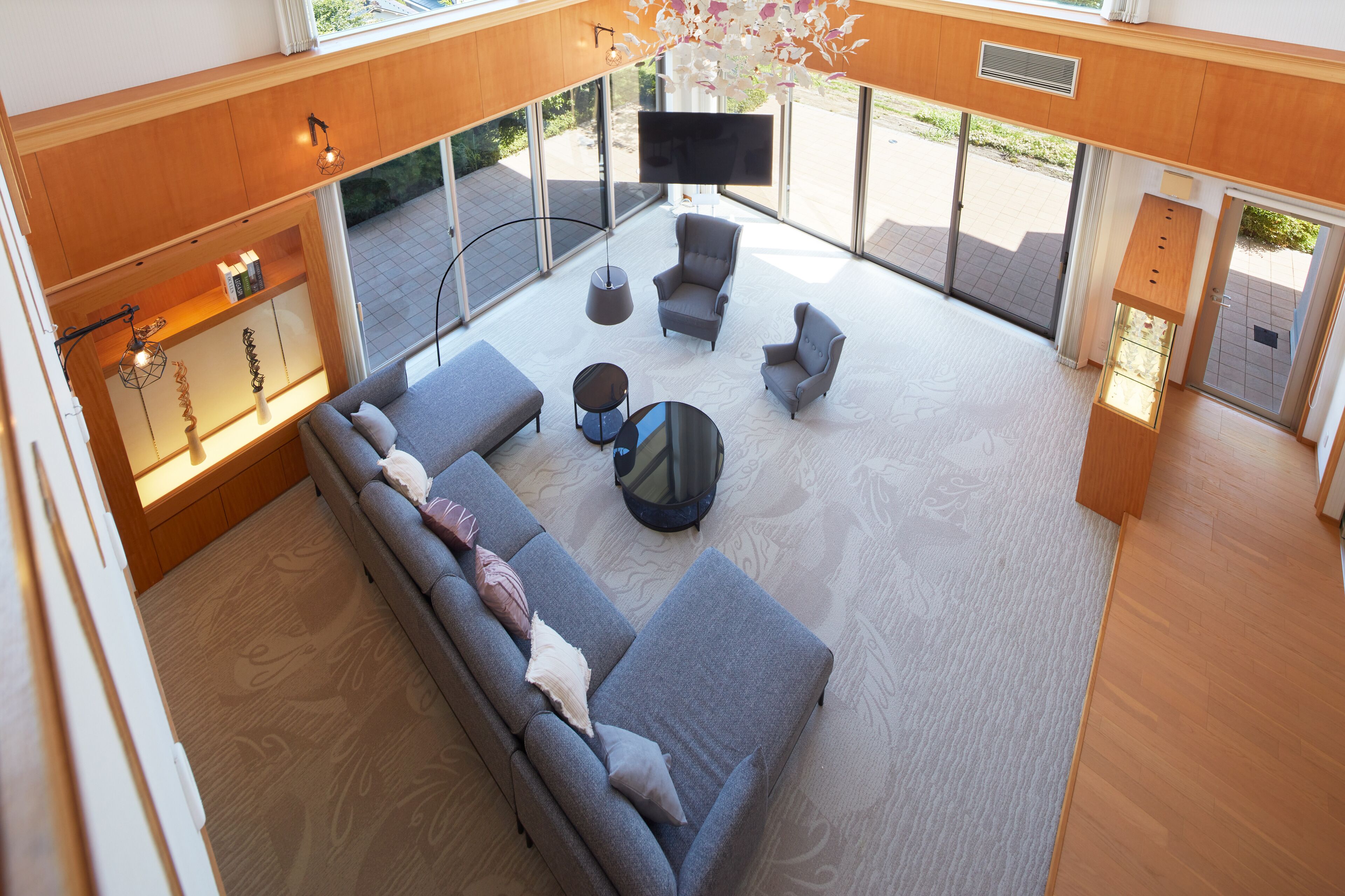 A modern living room with a sofa, armchairs, and a coffee table.