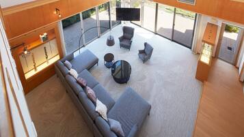 A modern living room with a sofa, armchairs, and a coffee table.