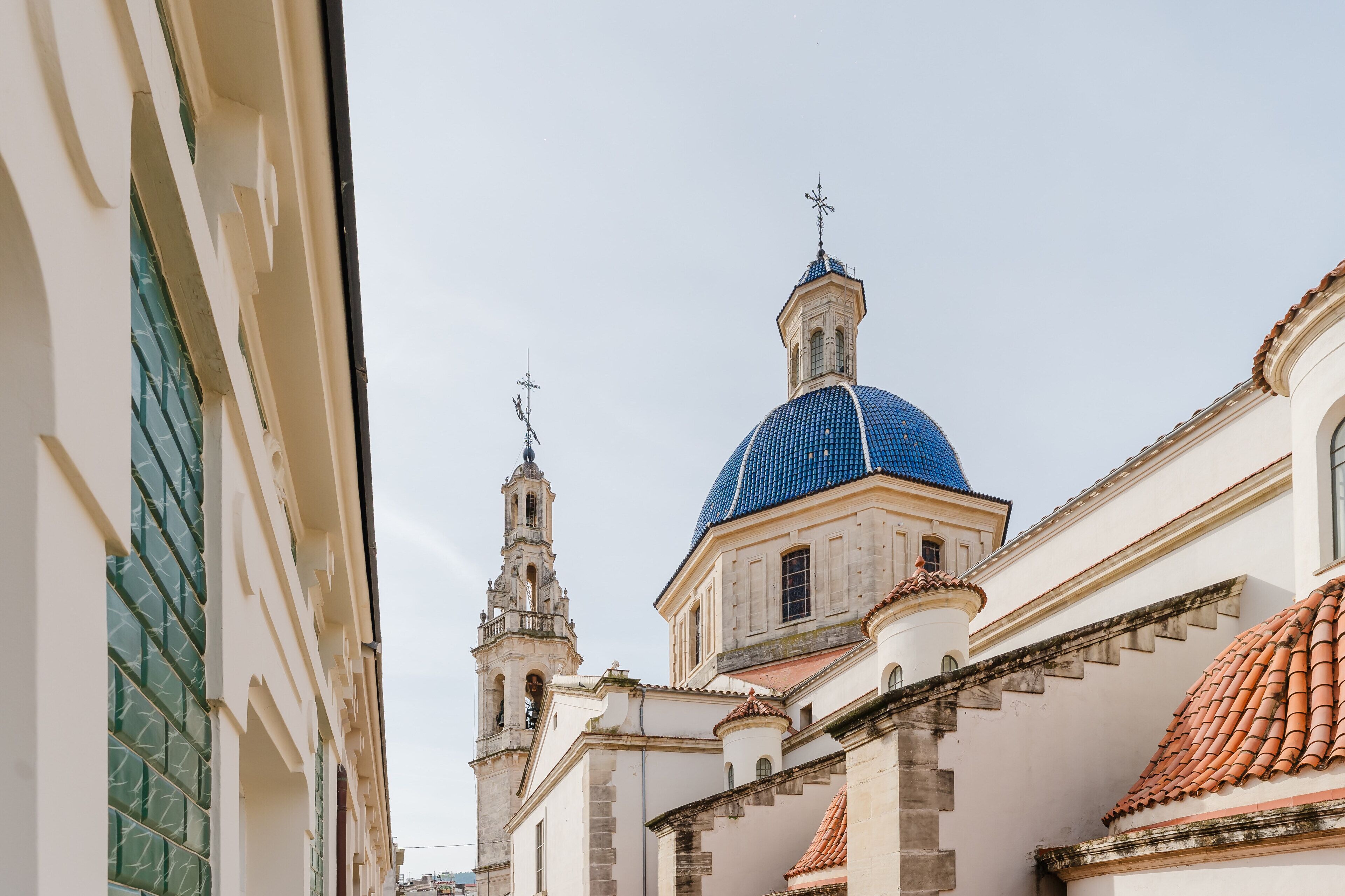 A building with a prominent blue dome and a bell tower.