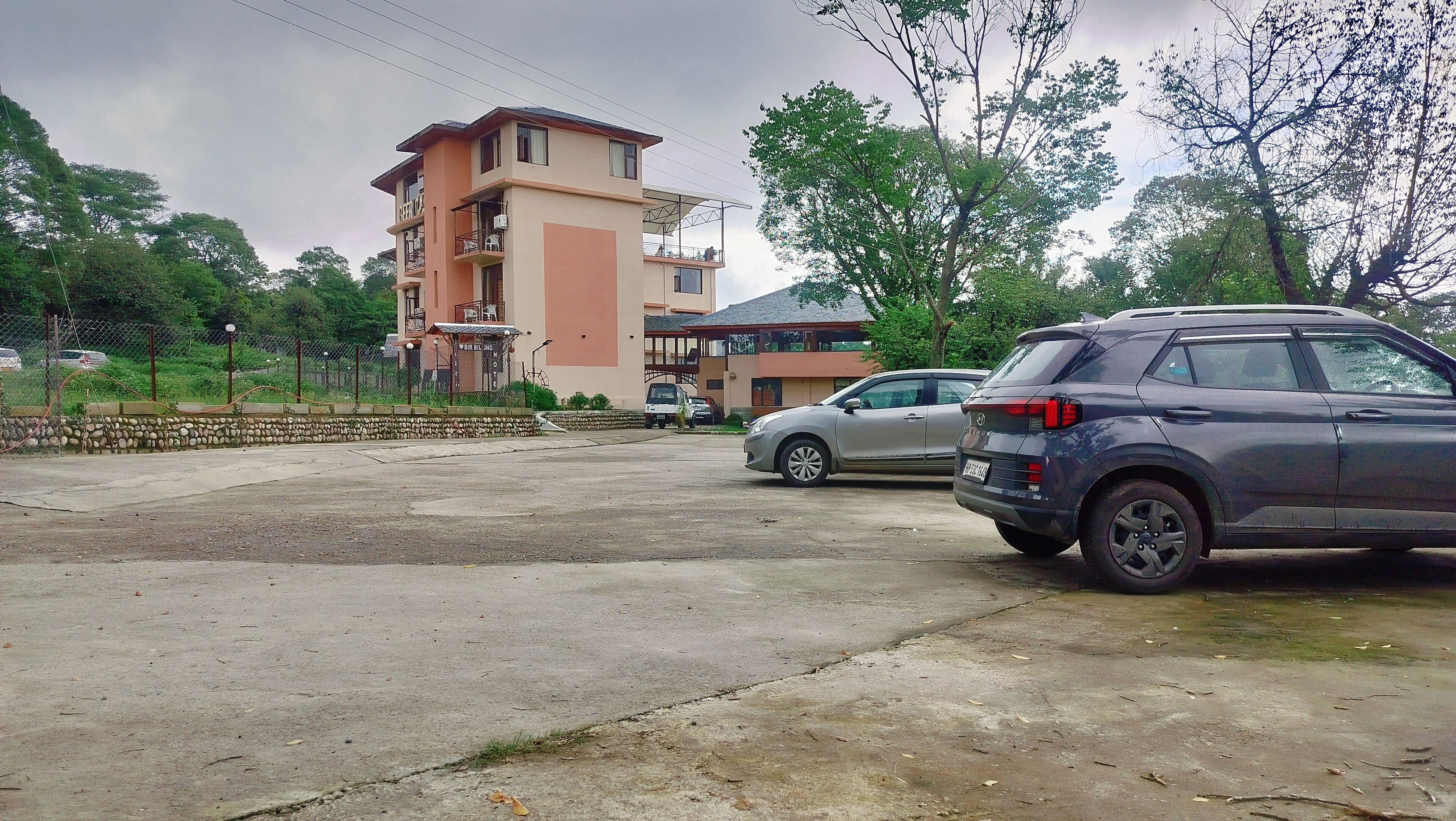A parking lot with a building in the background.