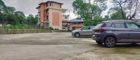 A parking lot with a building in the background.