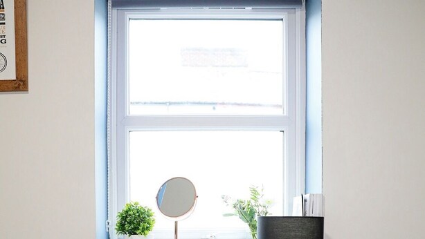 A small workspace with a desk, chair, kettle, and a window with a view. - The Old Bike Shop Accommodation (Norwich)