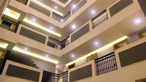 A multi-level interior with balconies, railings, and recessed lighting. - Ahuja Residency Mayfield Garden (Gurugram)