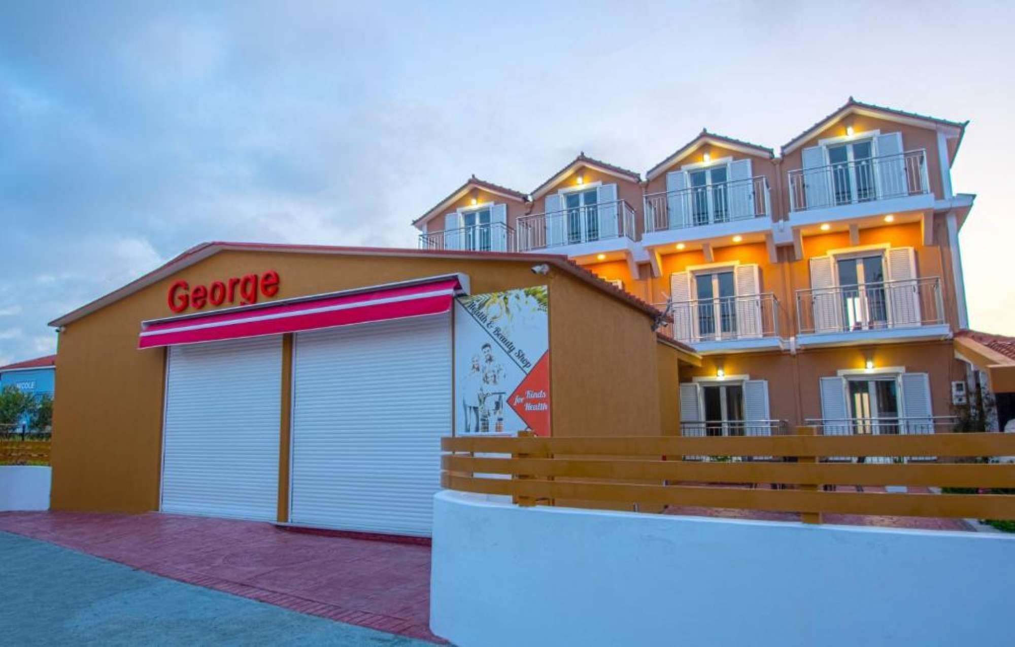 A building with a large garage door and a sign that reads "George."