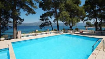 Seasonal outdoor pool, pool umbrellas, pool loungers