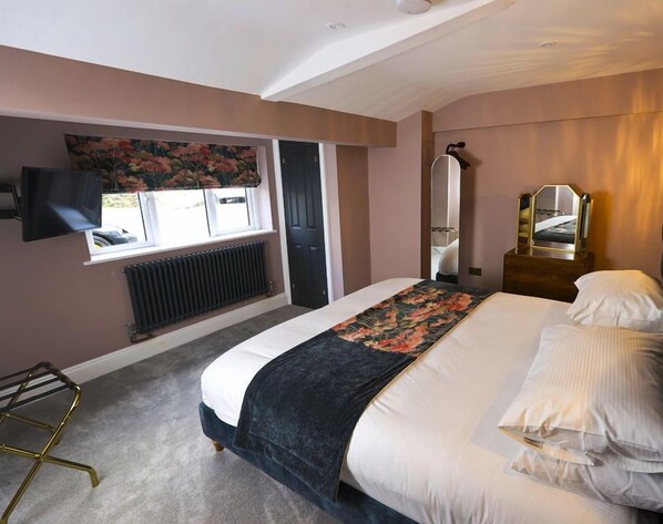 Experience luxury in one of Wainwright Apartment's two bedrooms, featuring a super king-size bed, a Smart TV, ample natural light streaming through the window, and premium linen for an unparalleled stay.