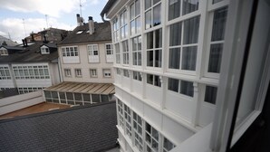 A multi-story building with white-framed windows and a flat roof.