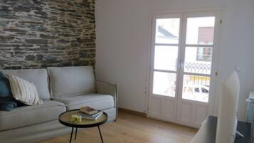 Superior Apartment | Living area | 50-inch Smart TV with digital channels
