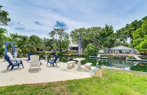 A patio area with outdoor seating and a pond.