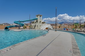 A swimming pool with a water slide, a tower, and a view of houses in the background. - 12 Mi to Sand Hollow: Spacious Home w/ Game Room (Washington)