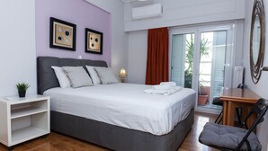 A bedroom with a bed, a desk, a chair, a shelf, and a window with curtains. - Classical Beauty 3Bd Apt in Nea Filothei (Athens)