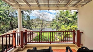 A covered balcony with a view of a lake and surrounding greenery. - Beautiful 3-bed Villa in Cherngtalay, Thalang (Choeng Thale)